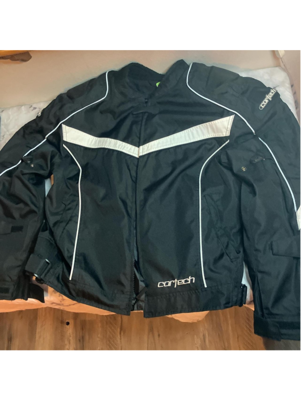 Black and white Cortech motorcycle jacket with padding, thermal layer not includ